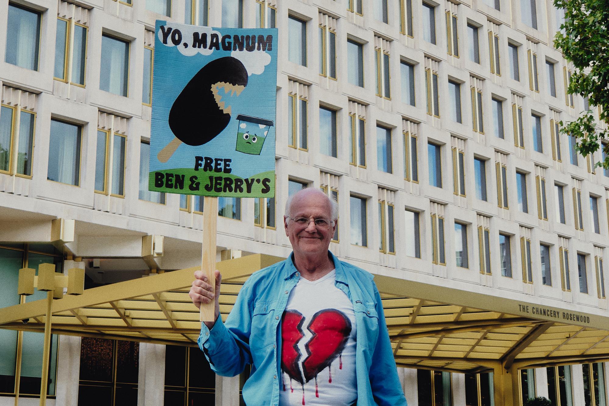 Ben Cohen holds a Free Ben and Jerry's sign